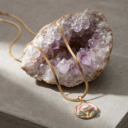 Gold necklace with a pendant on a geode crystal