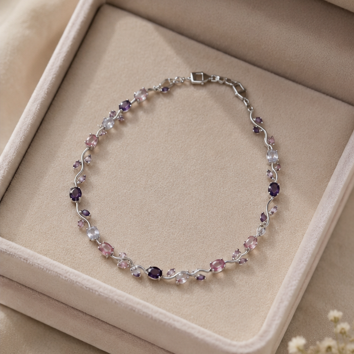 Multicolored beaded bracelet on a beige jewelry box with small white flowers.