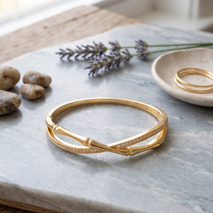 Gold bracelet on a marble surface with lavender and stones