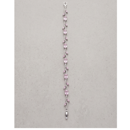 Silver bracelet with pink gemstones on a gray background