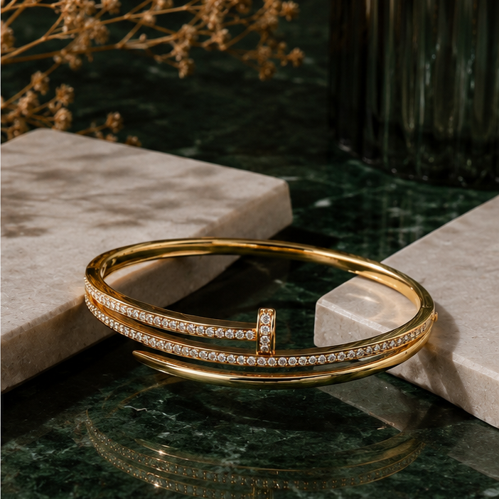 Gold bracelet with crystals on a dark marble surface